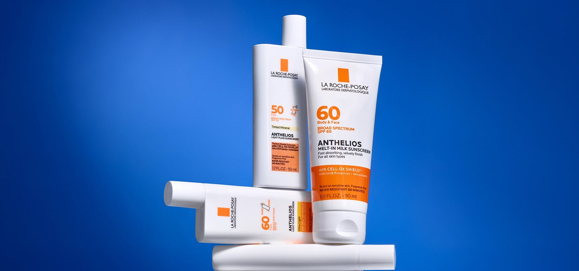 Collection of La Roche-Posay sunscreen products on a blue background