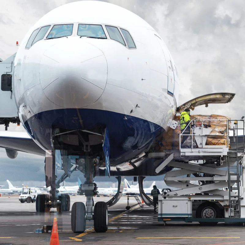 Commercial airplane being loaded with cargo at an airport