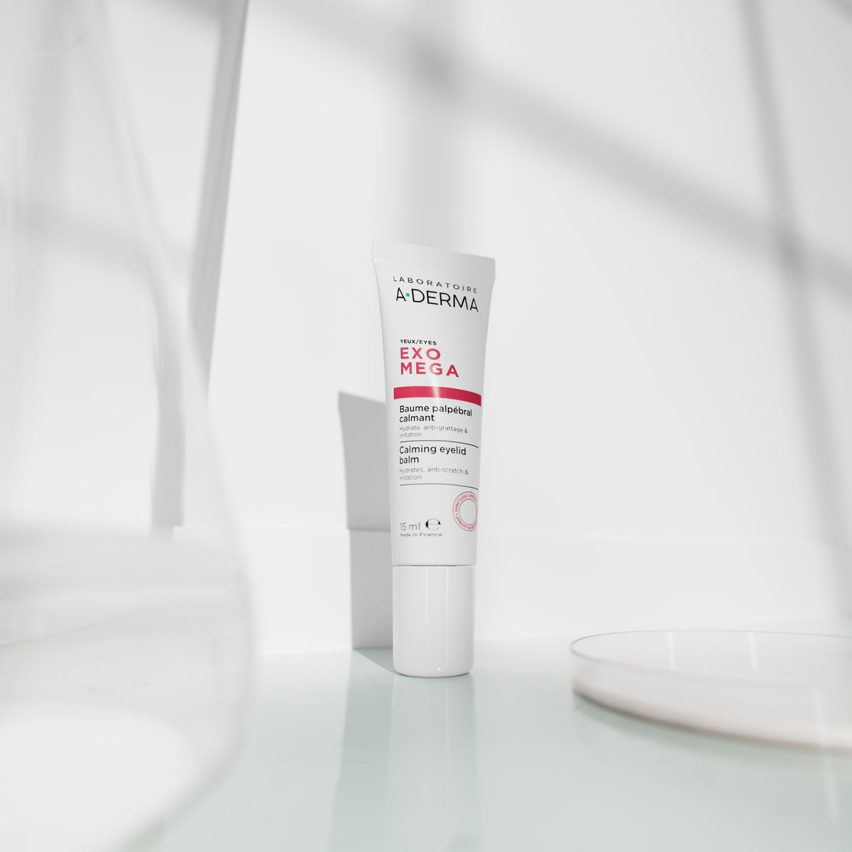 A-Derma Exomega, eyelid balm tube on a white shelf in soft light
