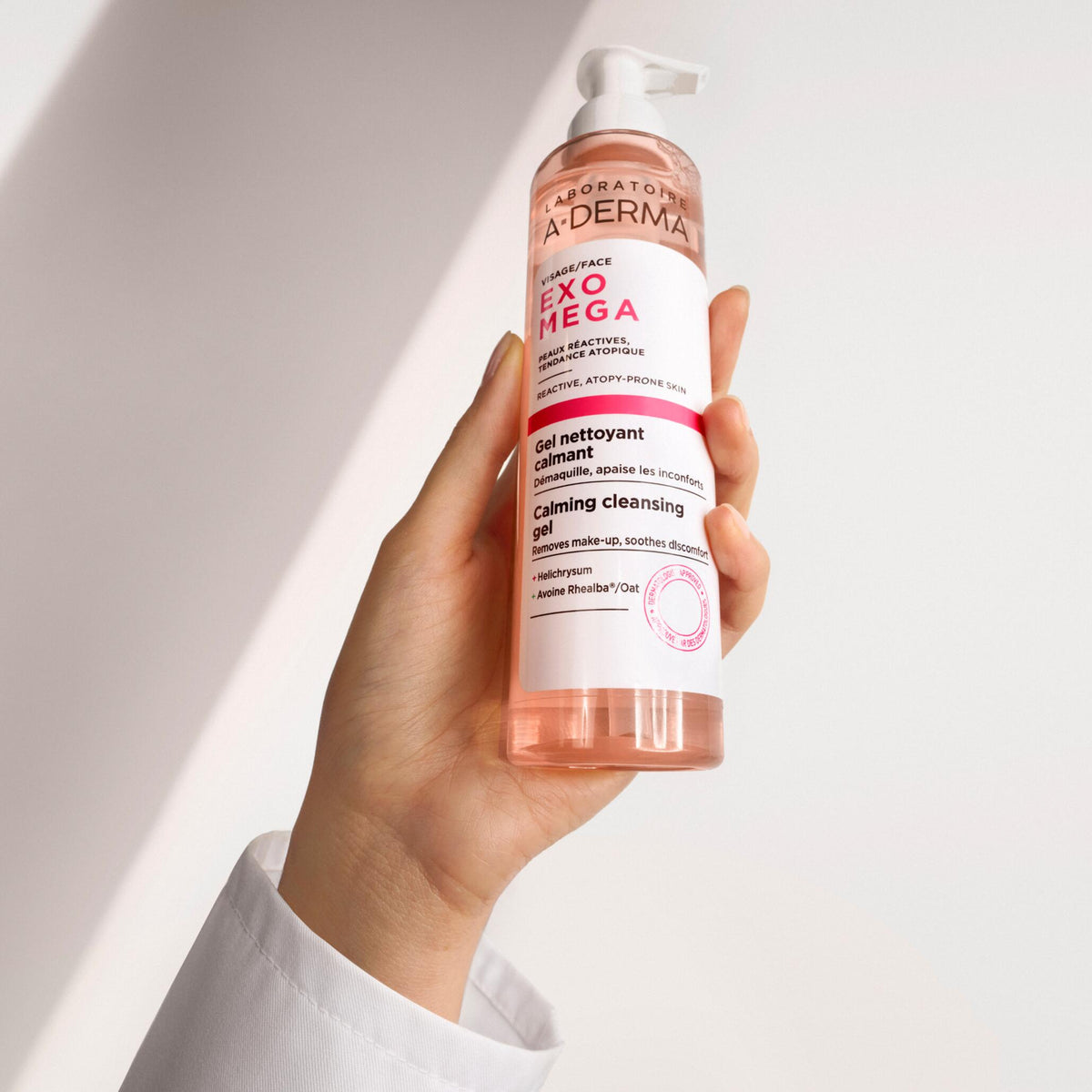 A-Derma Exomega, pump bottle held in one hand
