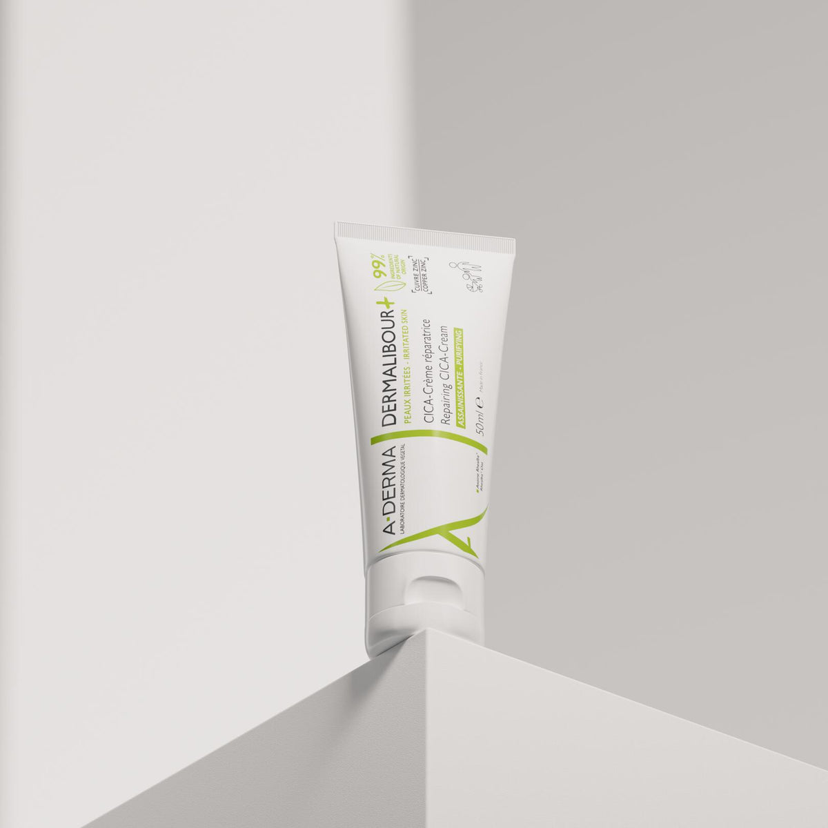 A-Derma Dermalibour+, tube standing on the corner of a white block