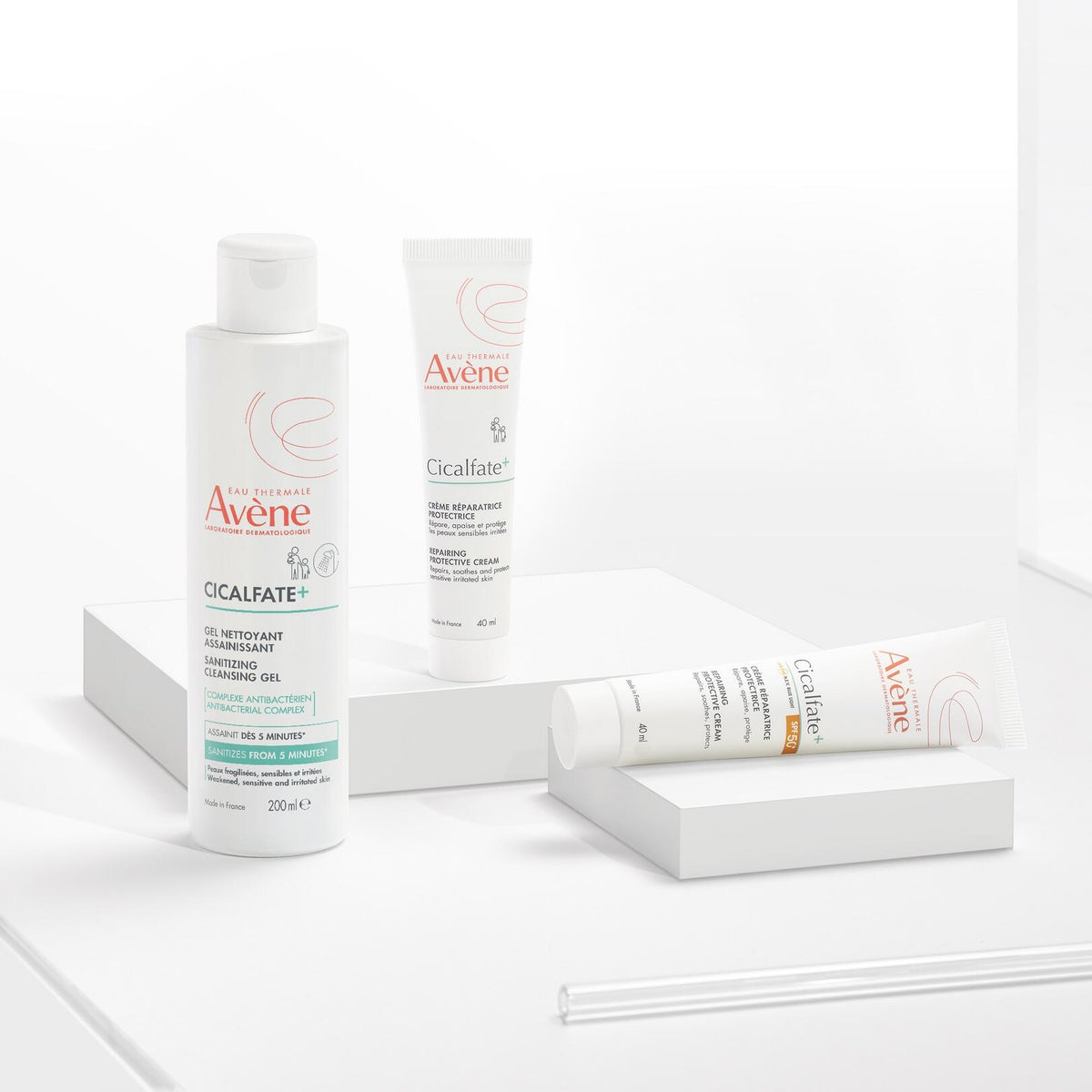Avène Cicalfate+, gel bottle with two Cicalfate+ tubes on white blocks