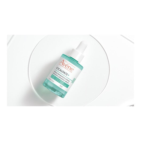 Avène Cicalfate+, dropper bottle on a glass disc, top view in a wide crop