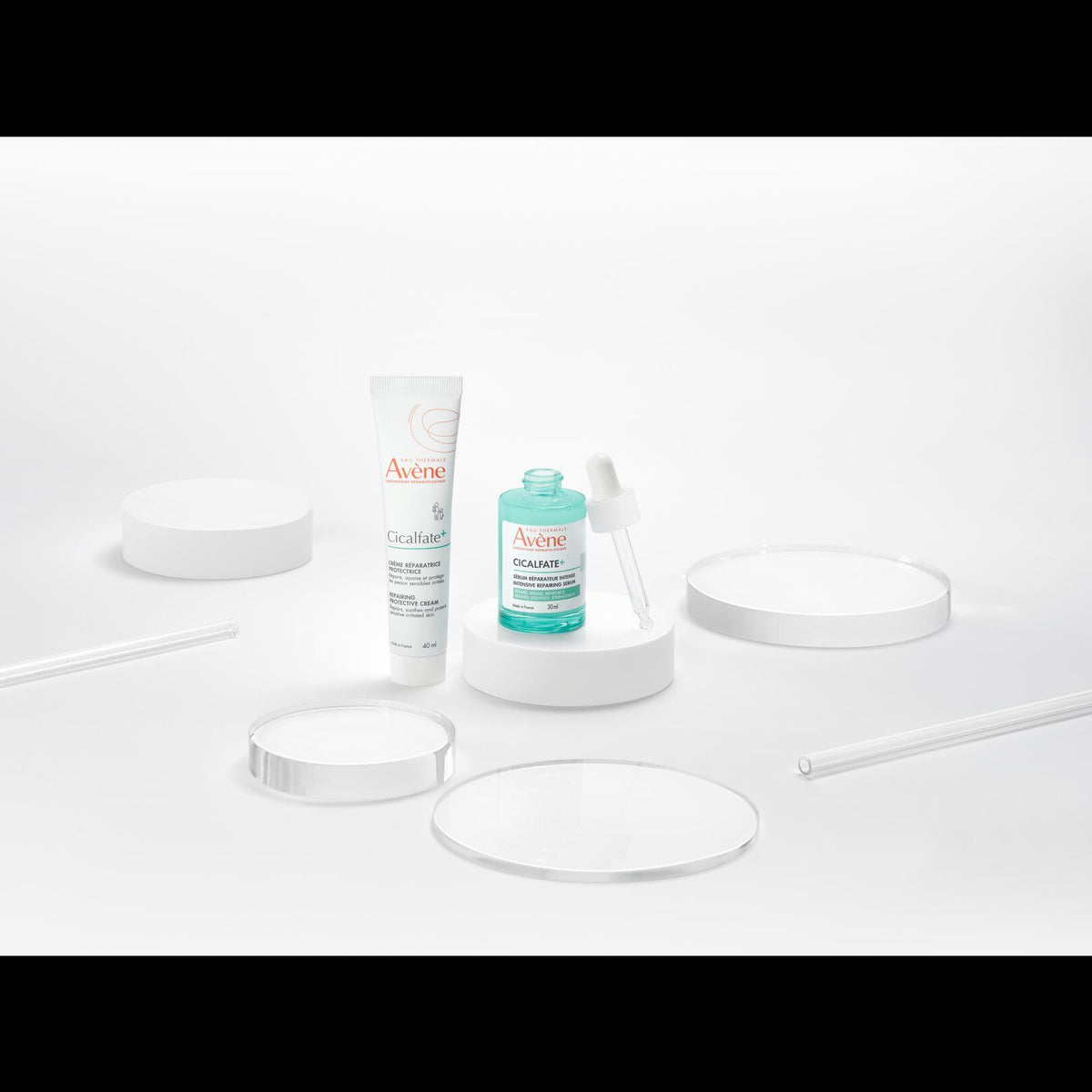 Avène Cicalfate+, tube and dropper bottle among glass discs