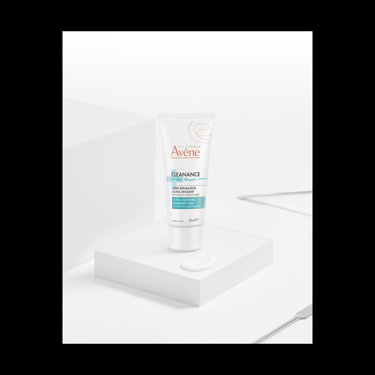 Avène Cleanance, tube on a white plinth with a dab of cream