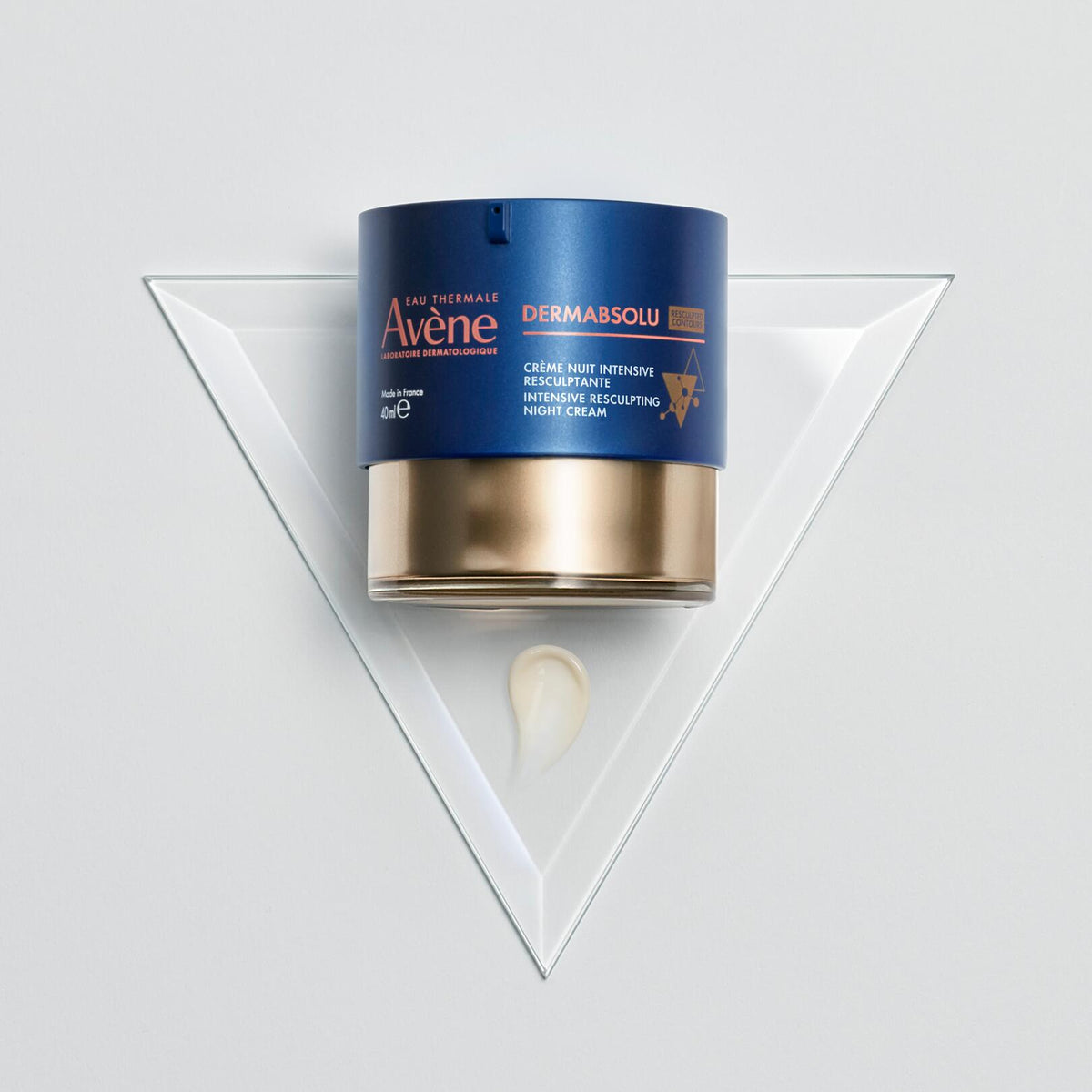 Avène DermAbsolu, jar and cream dab on a glass triangle