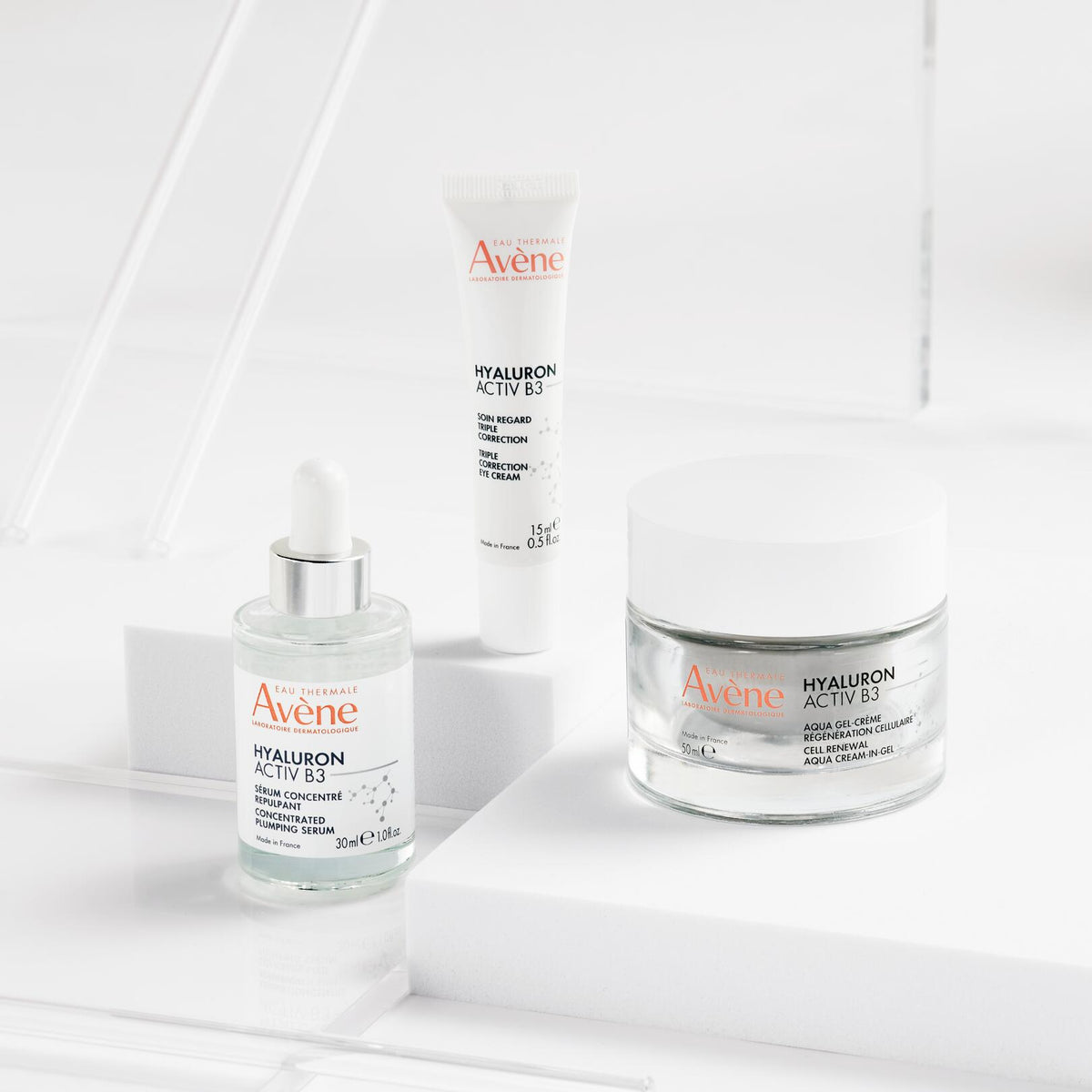 Avène Hyaluron Activ B3, serum, eye cream and jar on white blocks