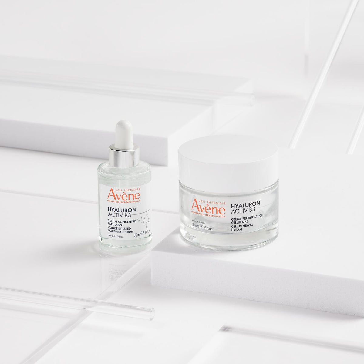 Avène Hyaluron Activ B3, serum bottle and jar on white blocks