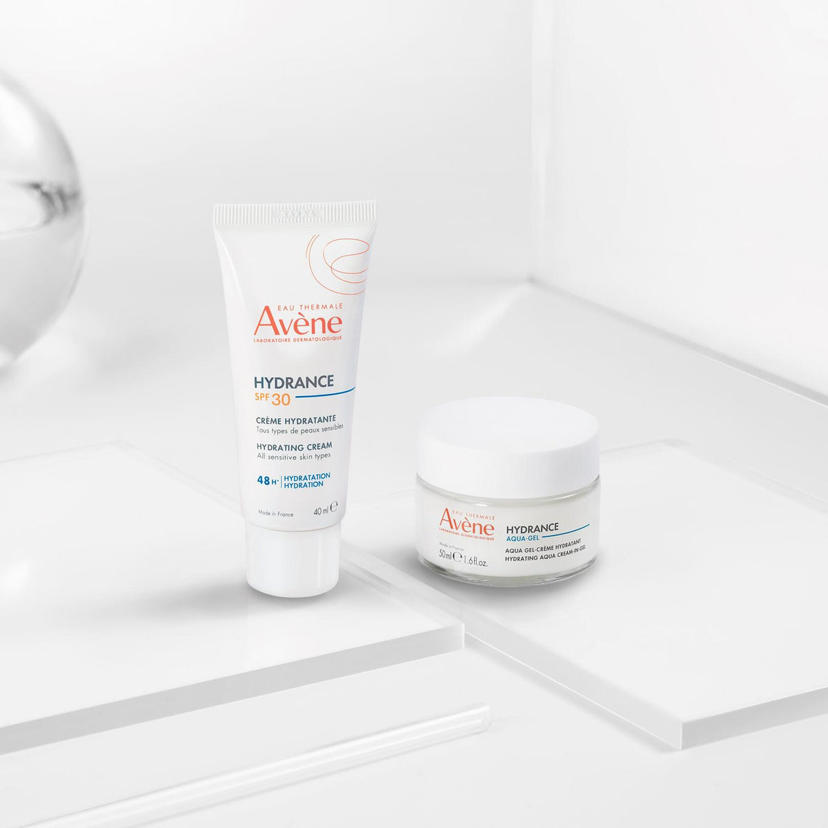 Avène Hydrance, jar and SPF 30 tube on glass blocks