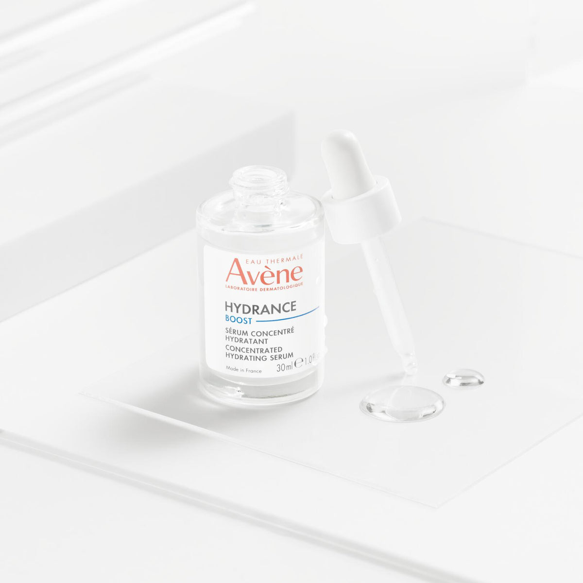 Avène Hydrance, dropper bottle with serum drops on a glass plate