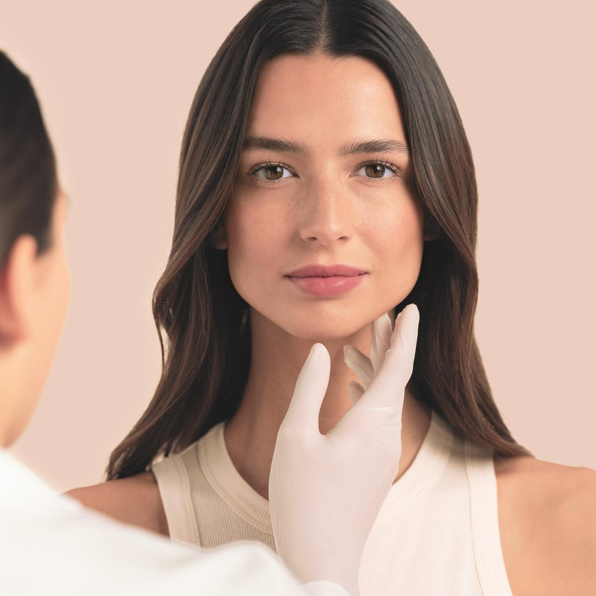 Avène Hydrance, gloved hand touching a woman's chin