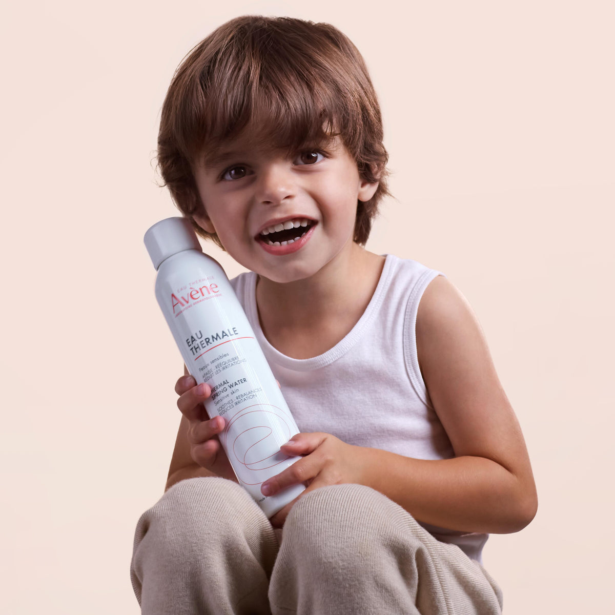 Avène Thermal Spring Water, smiling boy holding the spray can