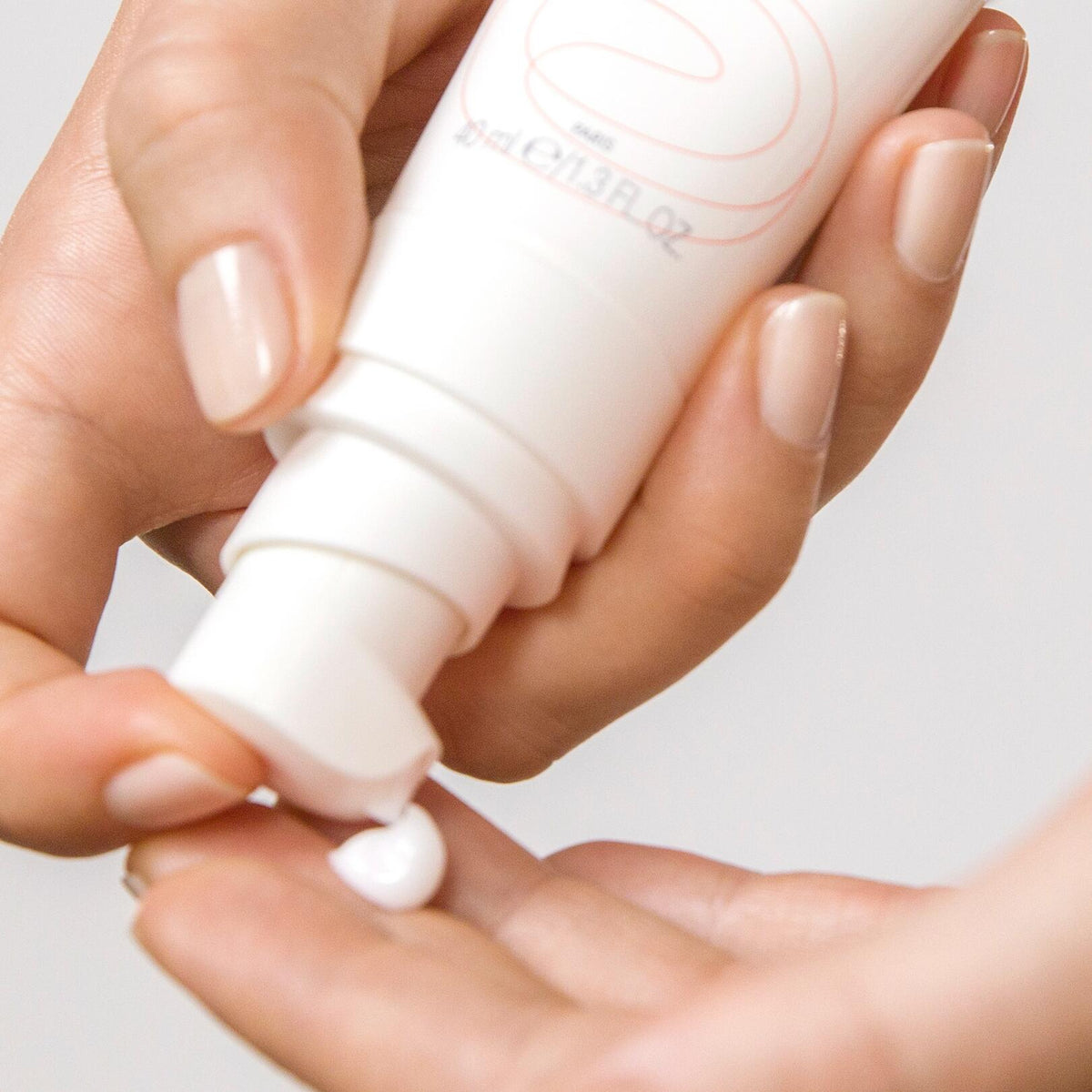 Avène Tolérance Control, cream pumped from the tube onto a fingertip, close-up