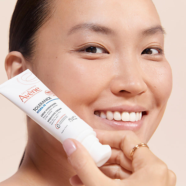 Avène Tolérance Hydra-10, smiling woman holding the tube