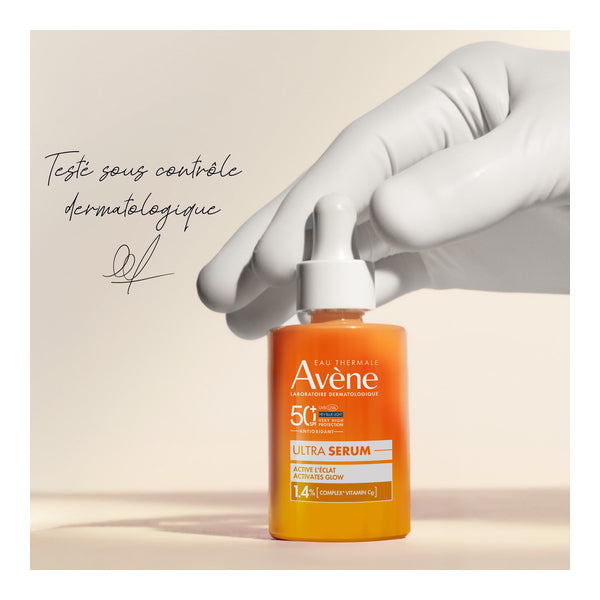 Avène Ultra Serum, gloved hand on the dropper bottle, handwritten note in French