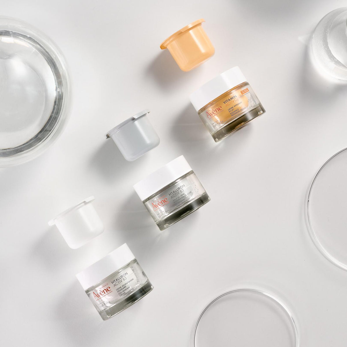 Avène Vitamin Activ Cg, jar beside two Hyaluron Activ B3 jars and their refills