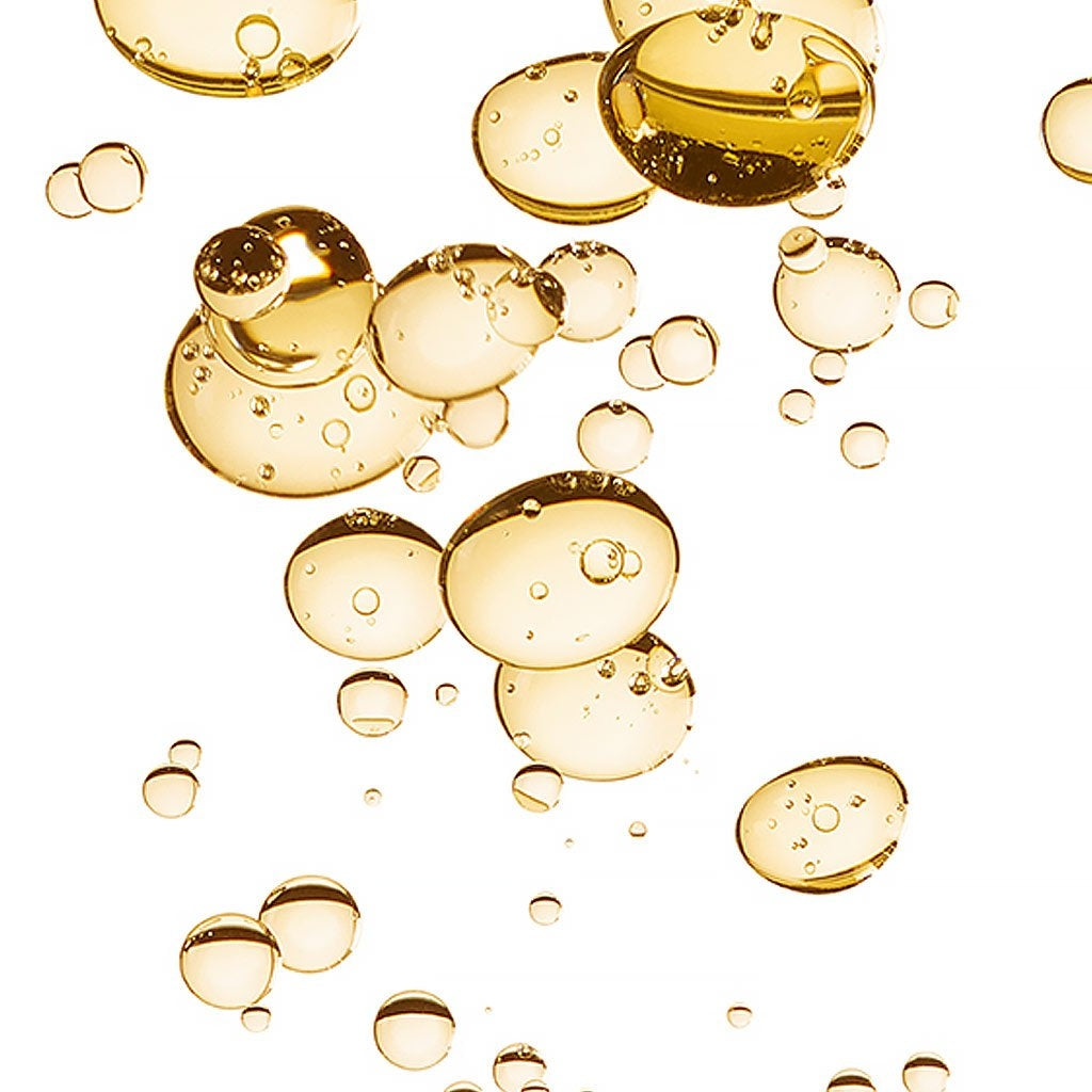 Bioderma Atoderm, golden oil bubbles filling the frame