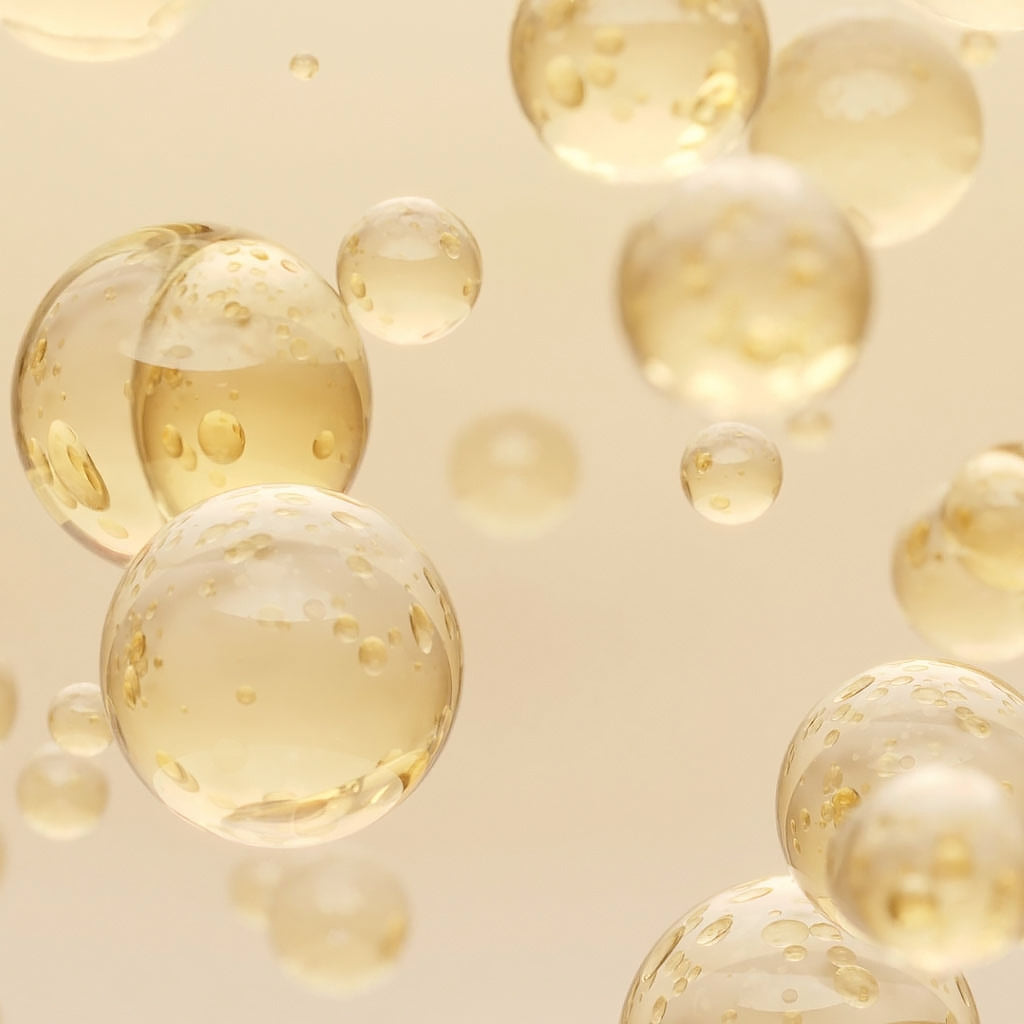 Bioderma Créaline, golden oil drops floating on a beige background