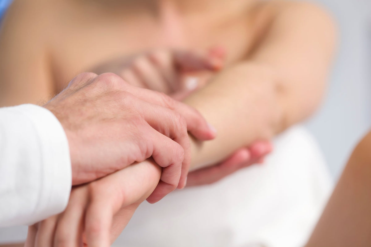 Bioderma Nodé P, hand in a white coat sleeve holding a forearm
