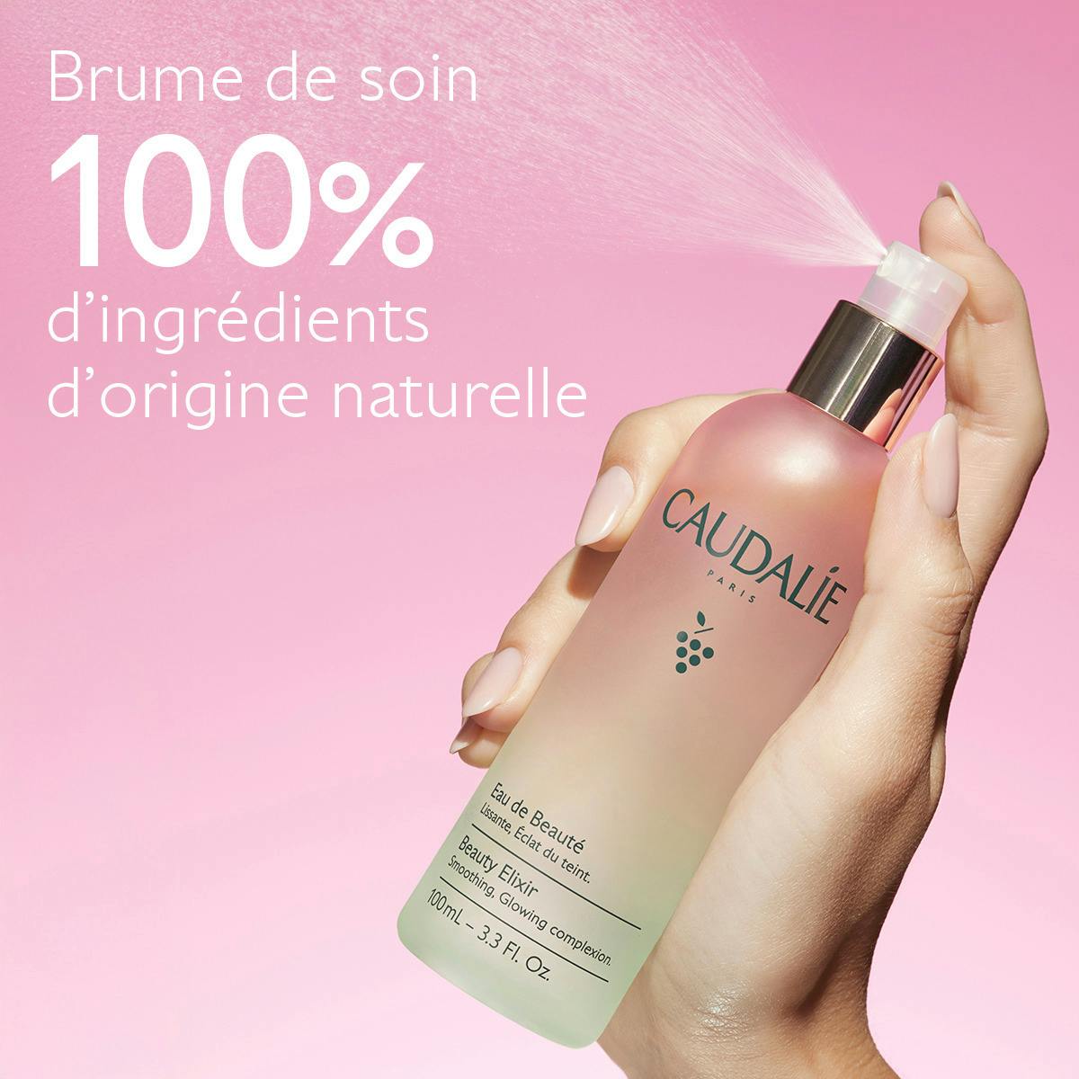 Caudalie Eau de Beauté, hand spraying the bottle, text in French