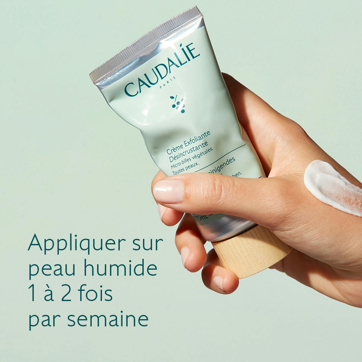 Caudalie Exfoliating Scrub Cream, hand holding the tube with directions in French