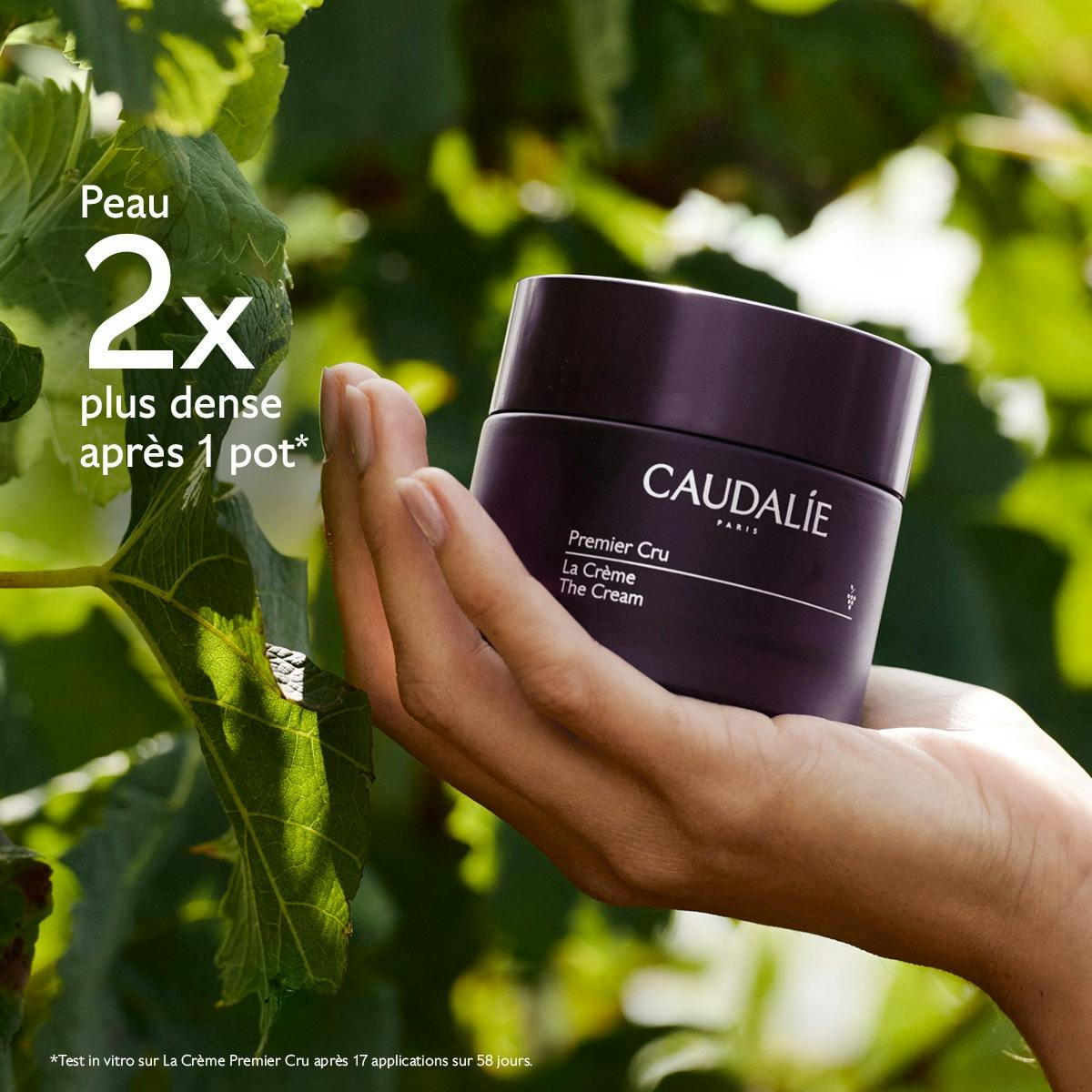 Caudalie Premier Cru, hand holding the jar among vine leaves, study results in French