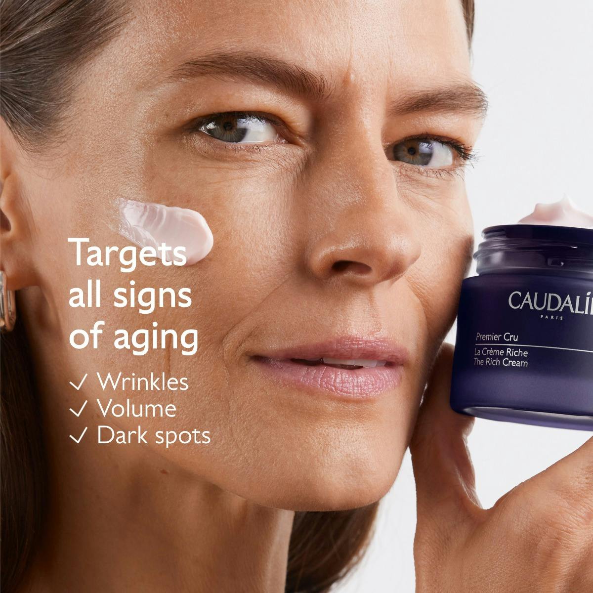 Caudalie Premier Cru, woman holding the jar with cream on her cheek