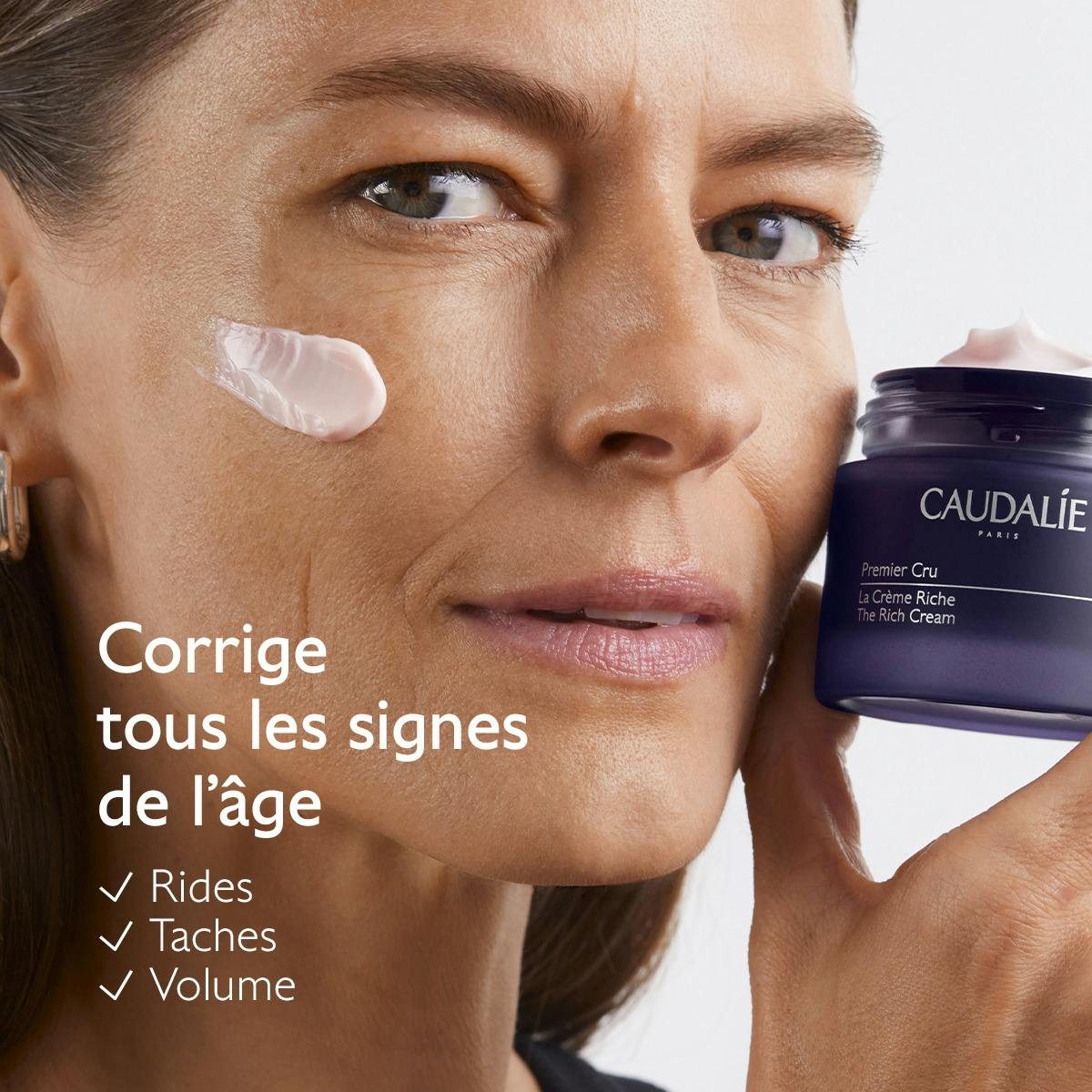 Caudalie Premier Cru, woman holding the jar with cream on her cheek