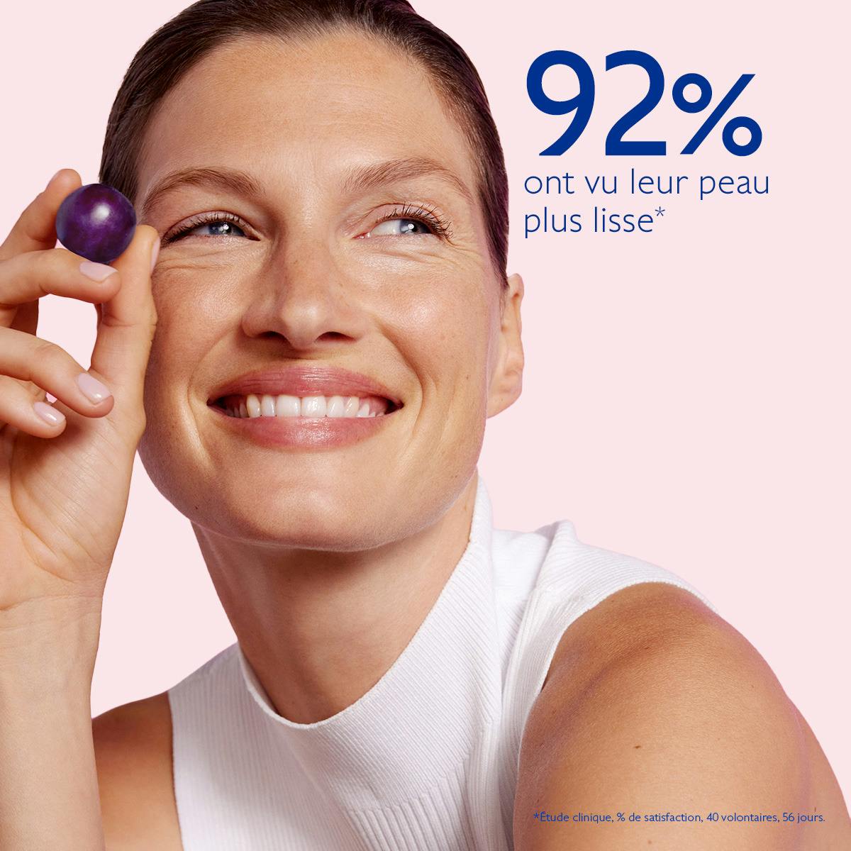 Caudalie Resveratrol-Lift, smiling woman holding a grape with study results in French