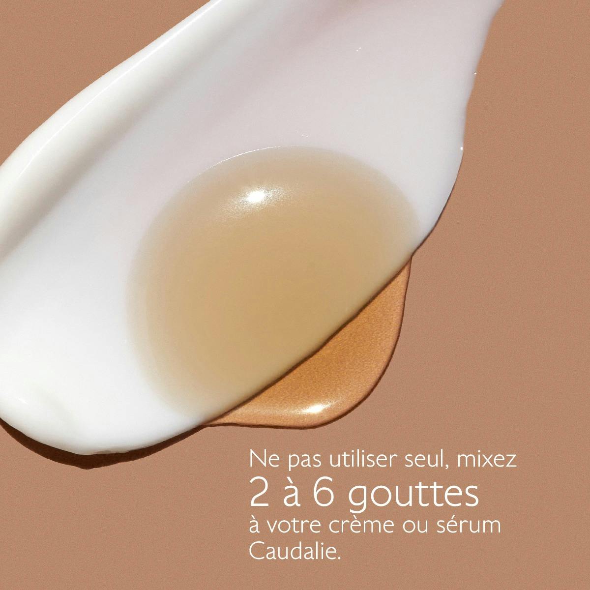 Caudalie Self-Tanning Sun Drops, drops mixed into a cream swatch with directions in French