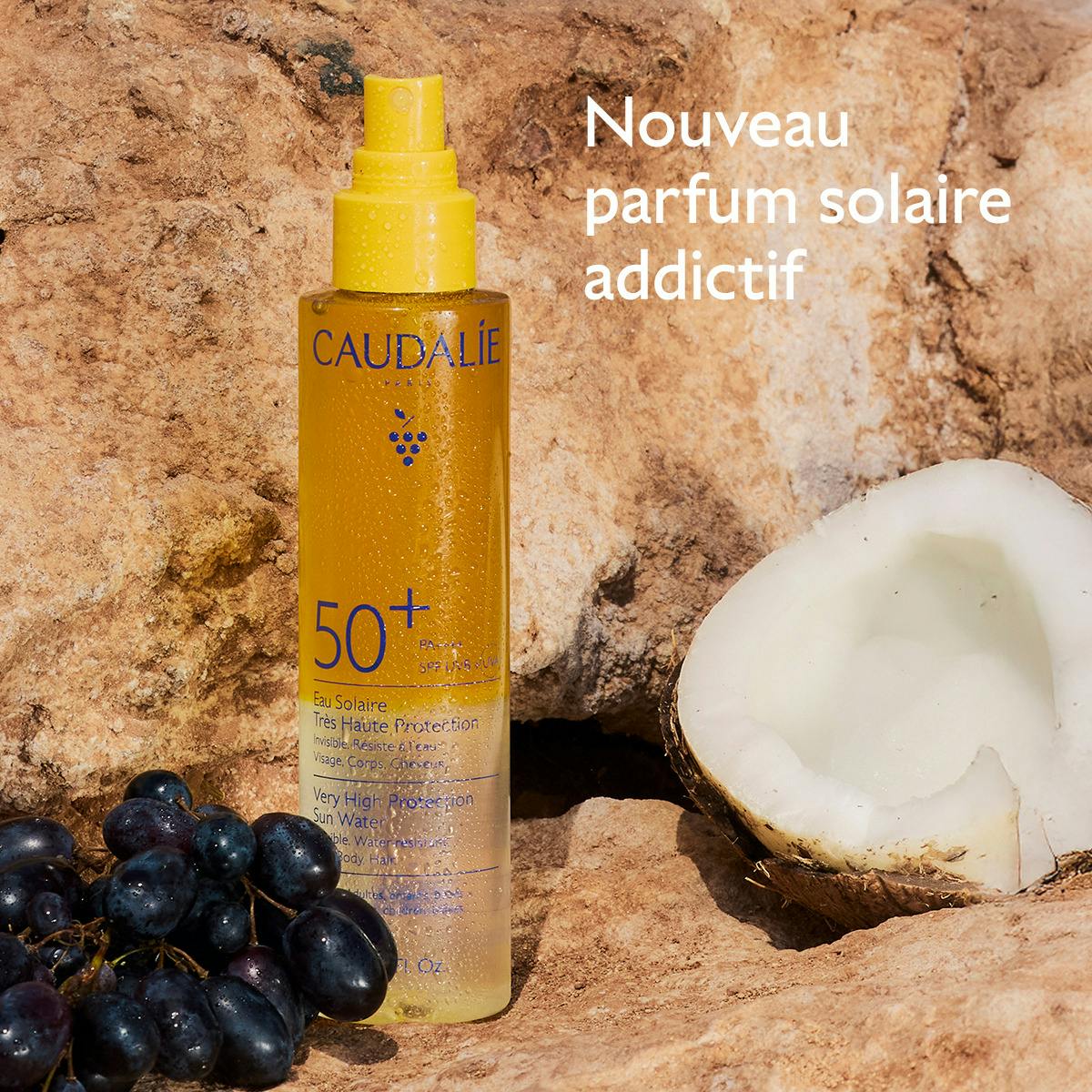 Caudalie Solaire, sun water bottle with black grapes and a coconut