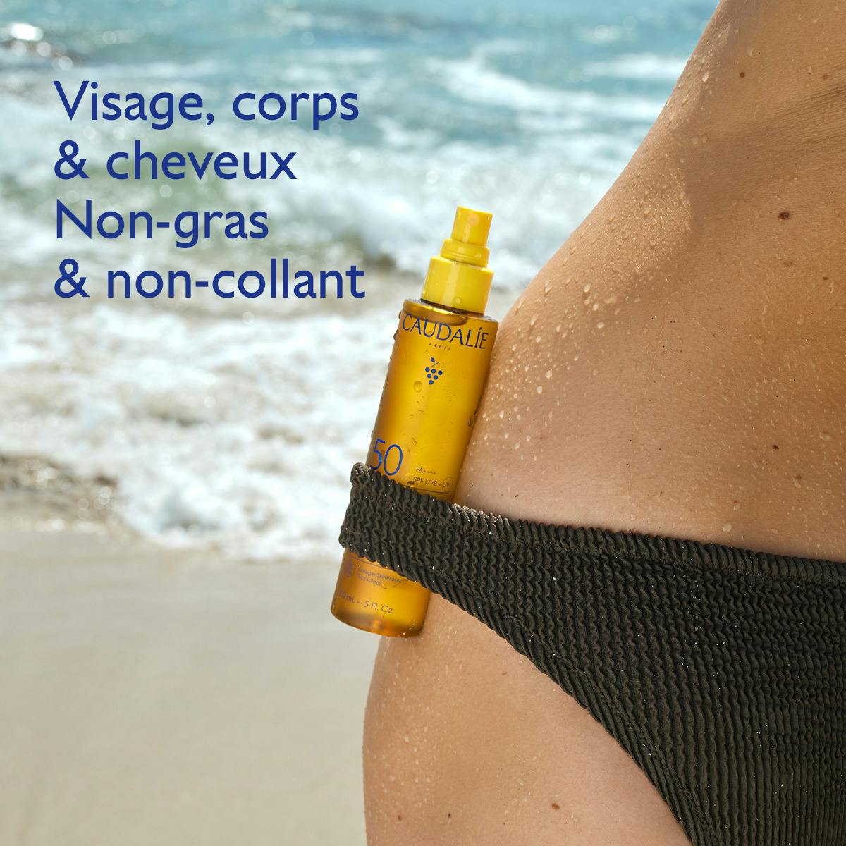 Caudalie Sublimating Sun Oil, spray bottle tucked into a bikini on wet skin