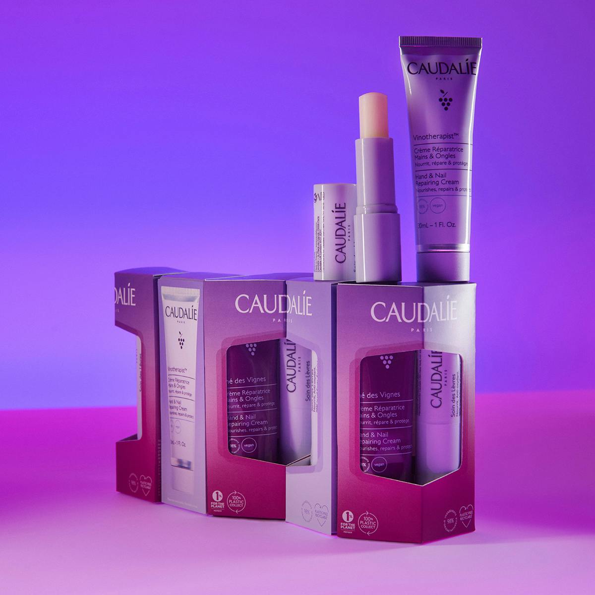 Caudalie Thé des Vignes, duo boxes with a Vinotherapist tube and lip balm on a purple background