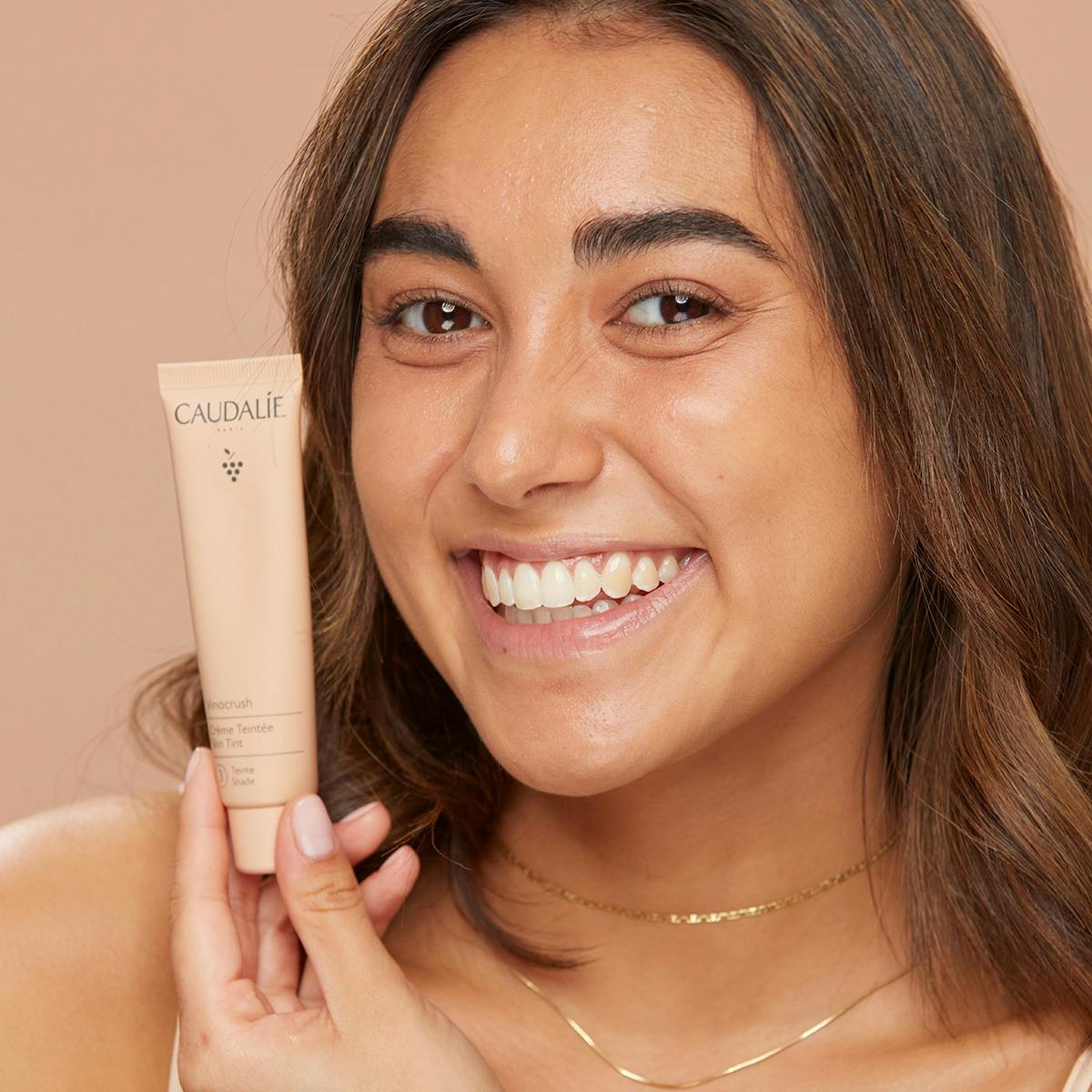 Caudalie Vinocrush, smiling woman holding the tube