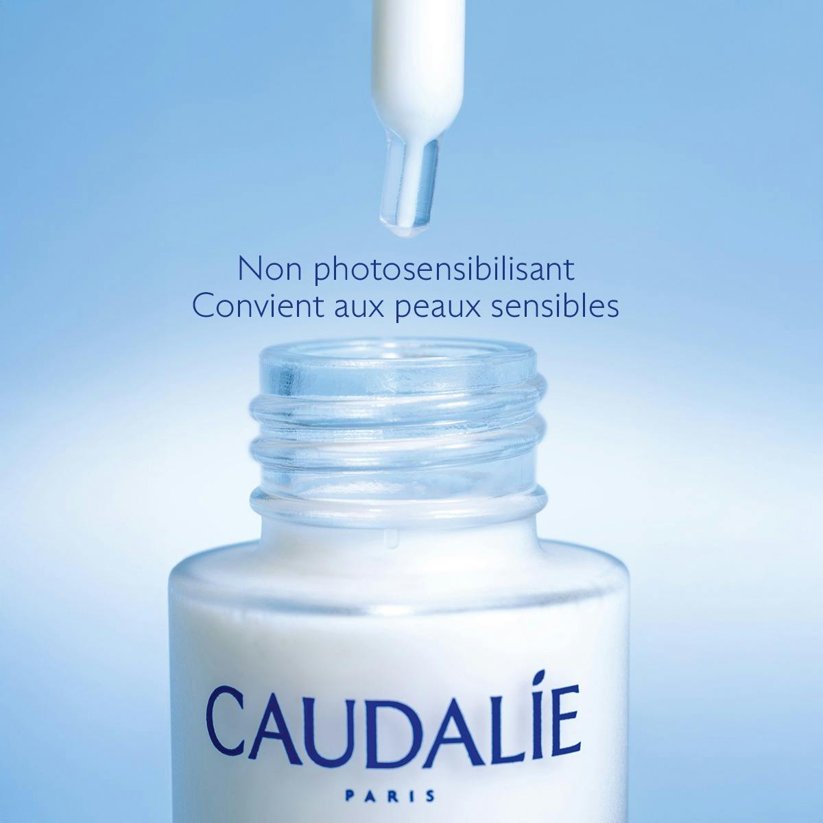 Caudalie Vinoperfect, dropper above the open glass bottle, text in French
