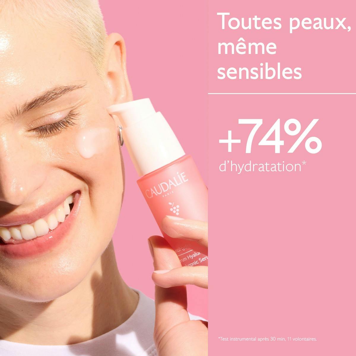 Caudalie Vinosource Hydra, smiling woman holding the pump bottle near her face