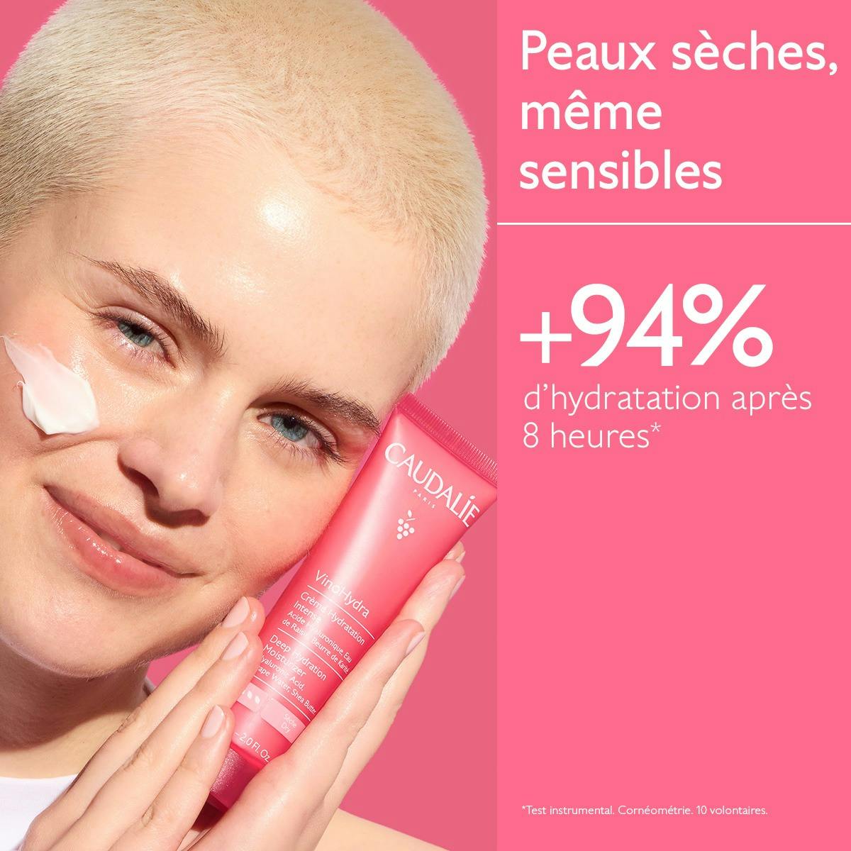 Caudalie Vinosource Hydra, woman holding the tube to her cheek with a dab of cream