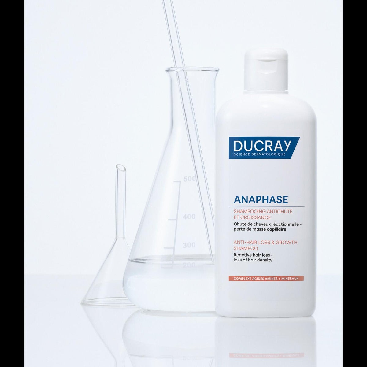 Ducray Anaphase, bottle next to laboratory glassware