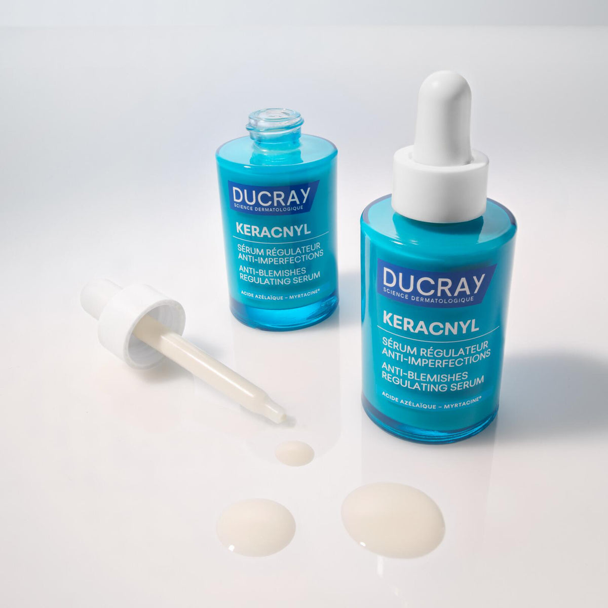 Ducray Keracnyl, two glass bottles with the dropper and serum drops