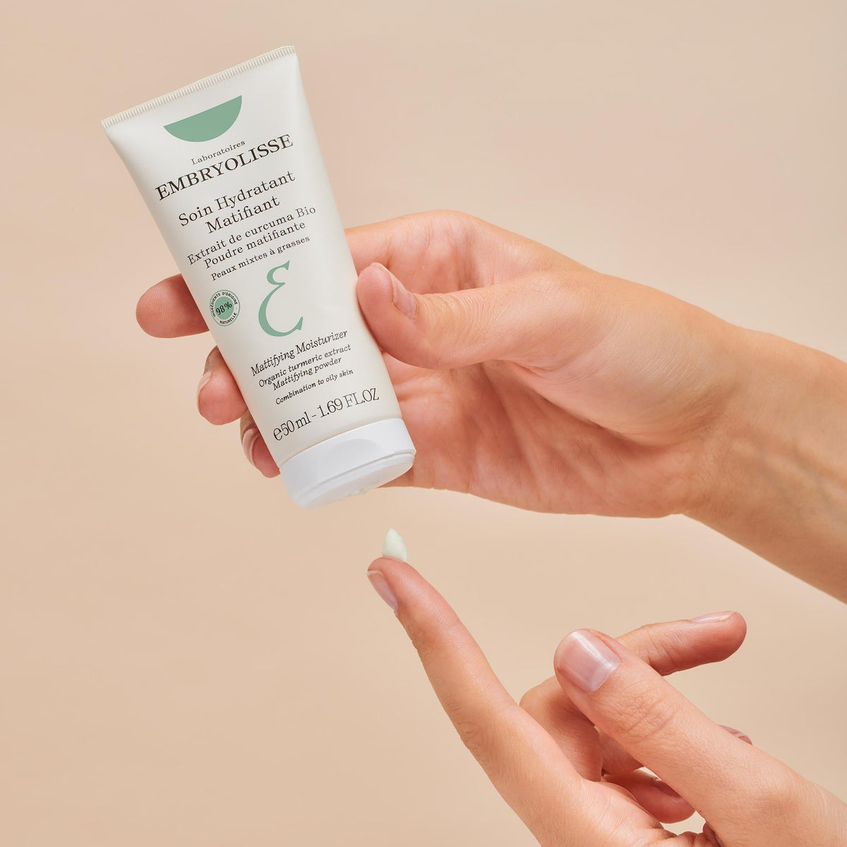 Embryolisse Mattifying Moisturizer, cream dispensed on a fingertip