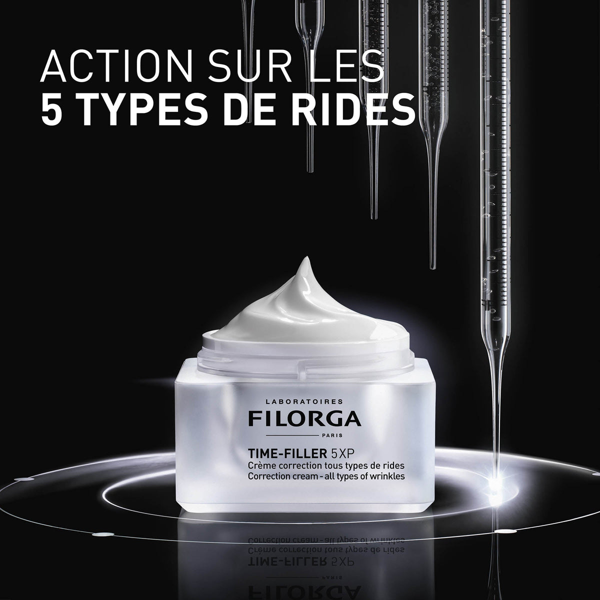 Filorga Time-Filler, open jar under glass pipettes on black with text in French