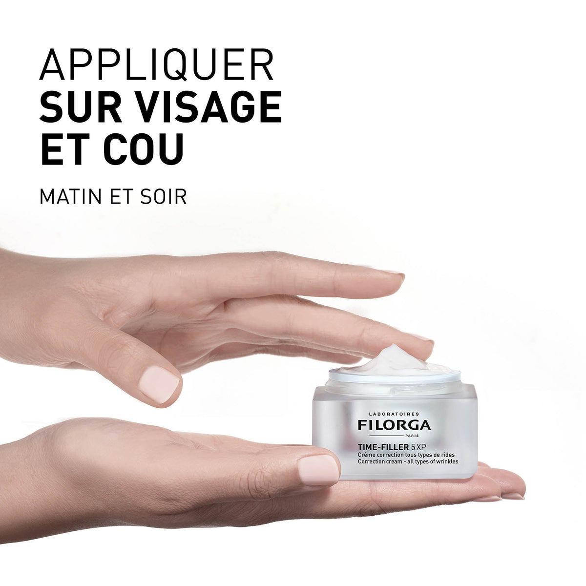 Filorga Time-Filler, hand holding the open jar with directions in French