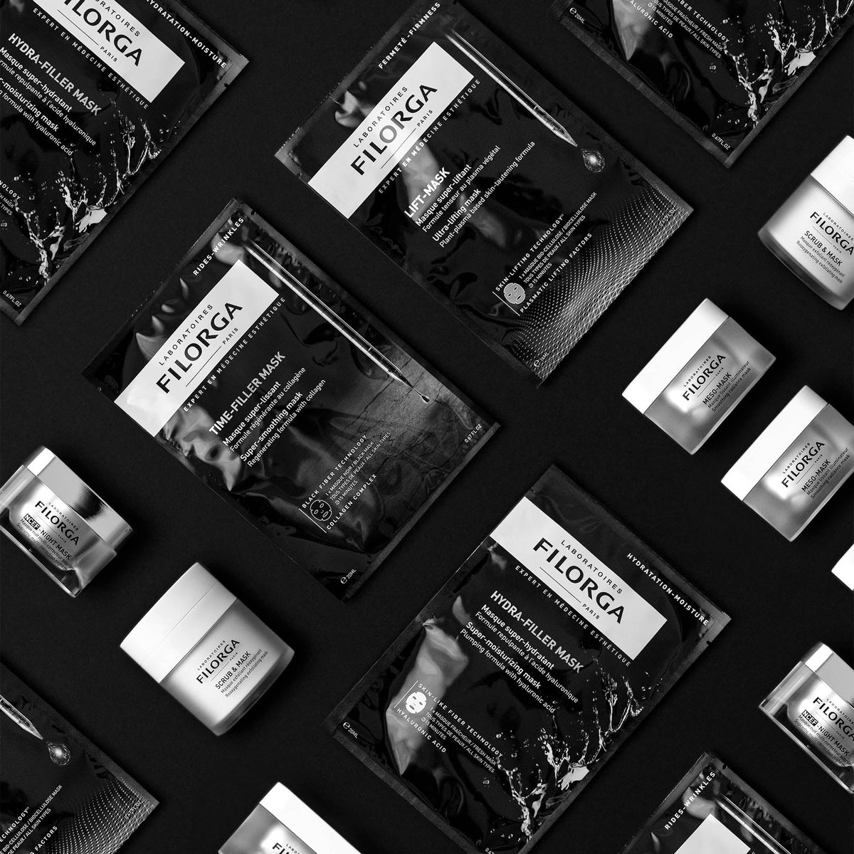 Filorga Time-Filler, flat lay of sheet mask sachets and jars on black