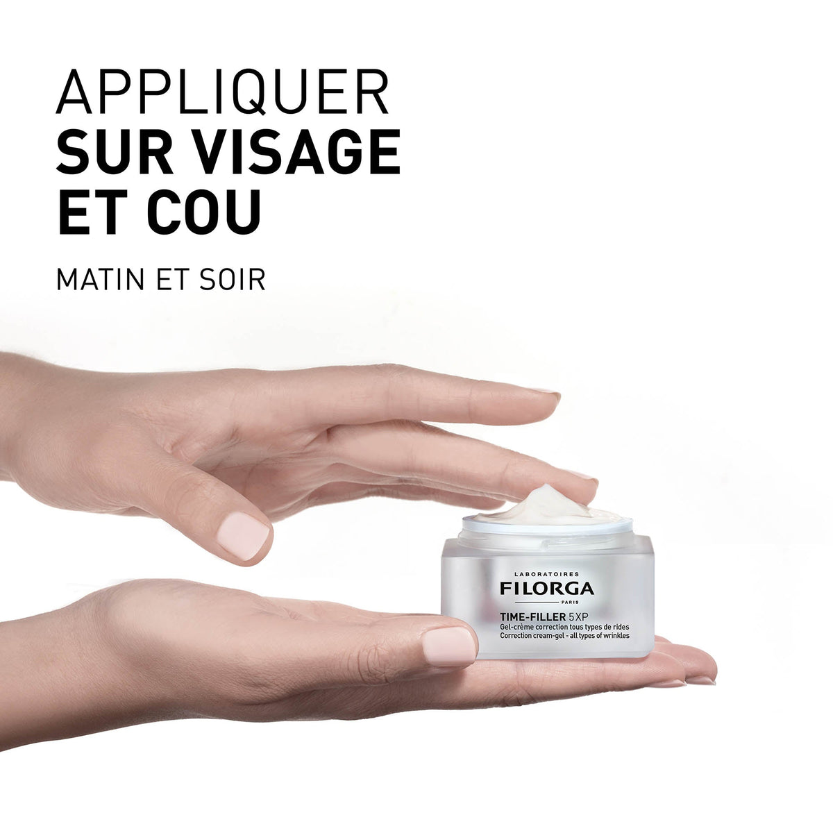 Filorga Time-Filler, hand holding the open jar with directions in French