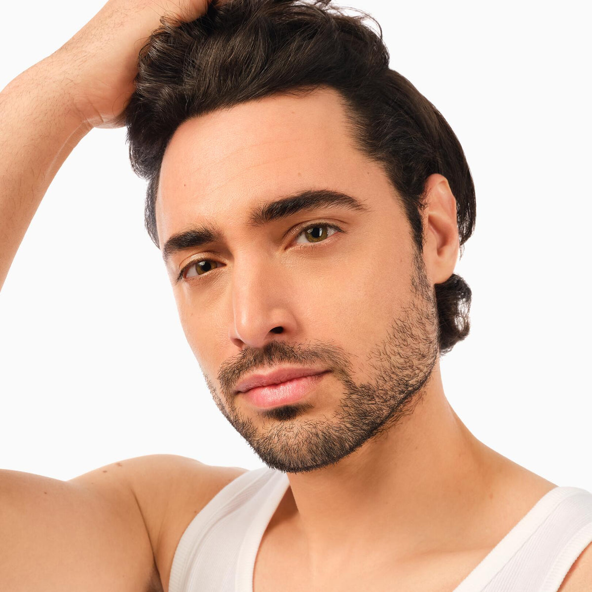 Klorane Fortifying Serum, man running a hand through his dark hair