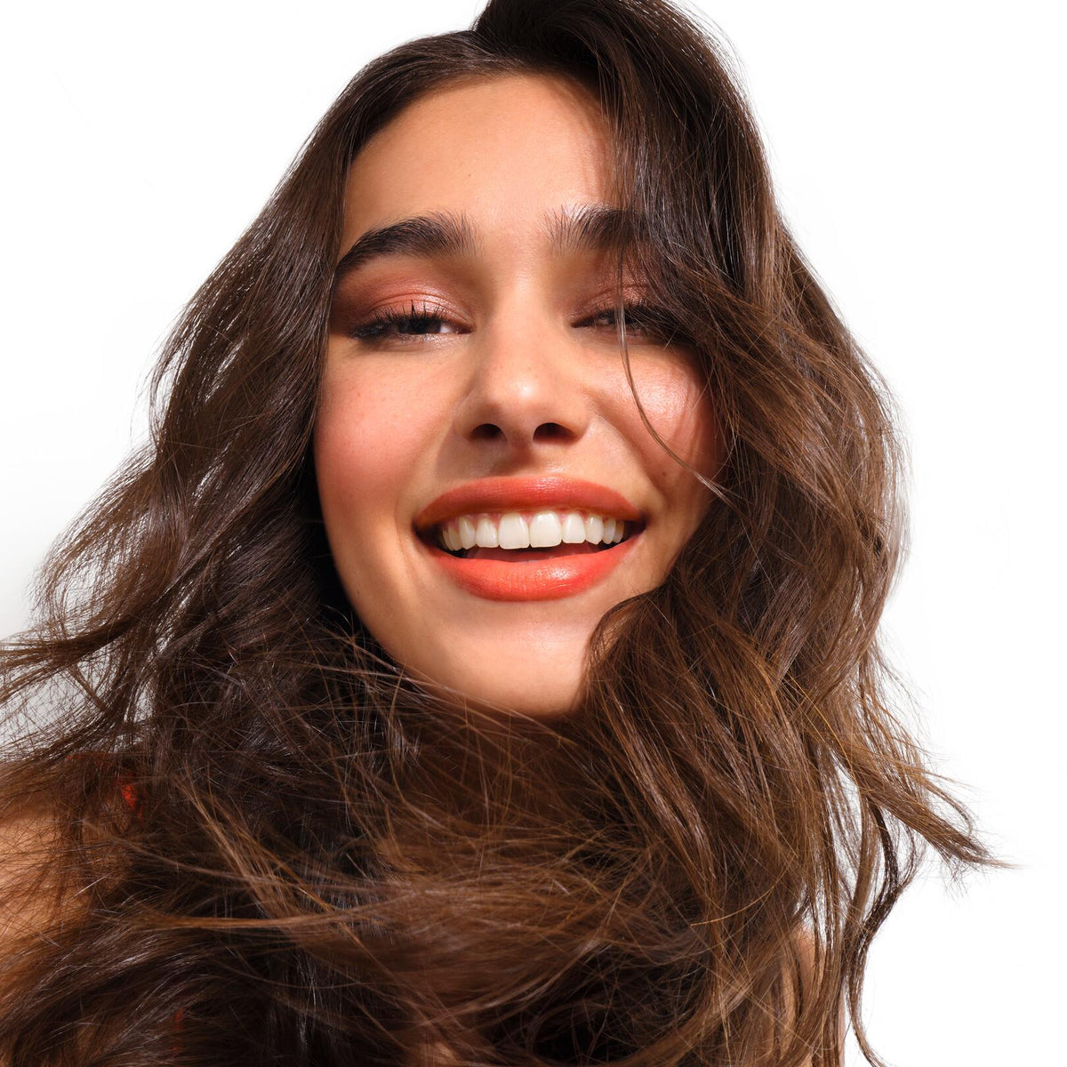 Klorane Mango, smiling woman with long wavy brown hair