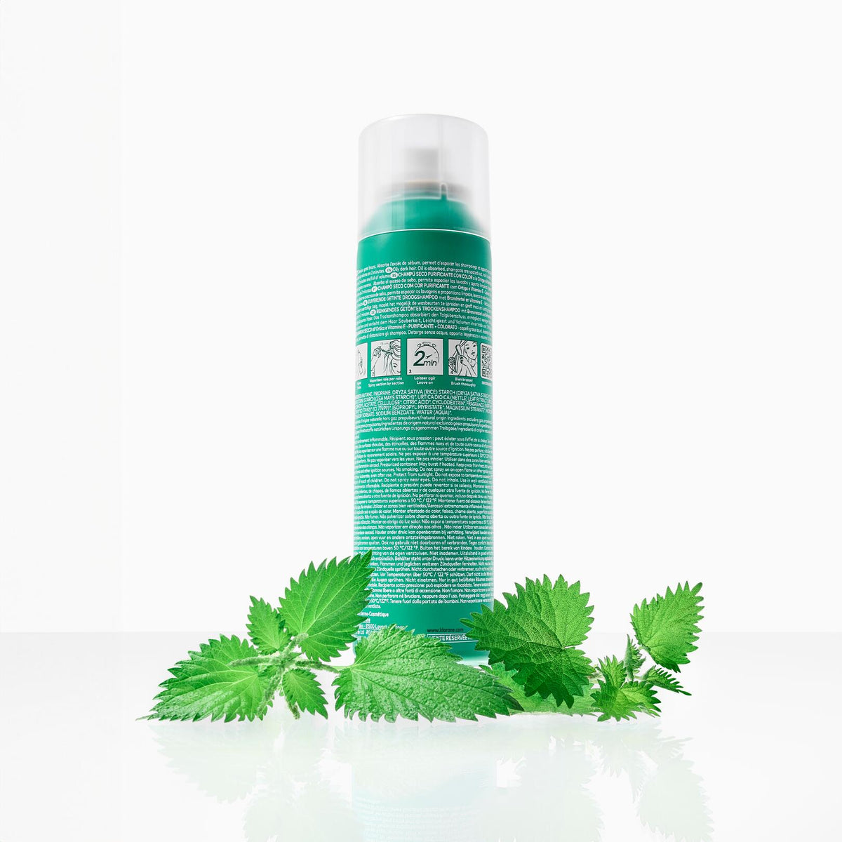 Klorane Nettle Tinted Dry Shampoo, back of the spray can among nettle leaves