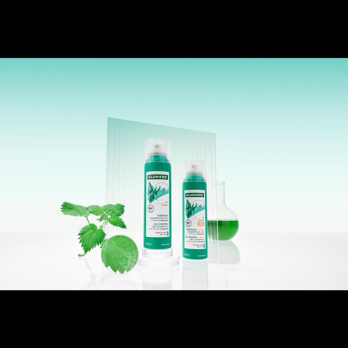 Klorane Nettle Tinted Dry Shampoo, two spray cans with nettle leaves on a mint background