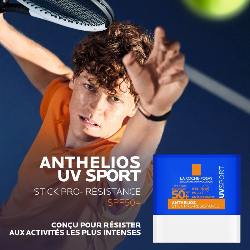 La Roche-Posay Anthelios, tennis player serving beside the stick