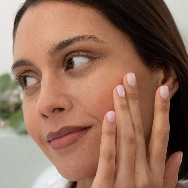 La Rosée Good Look Serum, close-up of a woman touching her cheek